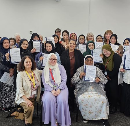 Group of students smiling and holding their certificates Image