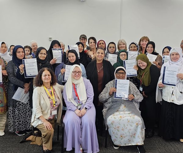 Group of students smiling and holding their certificates