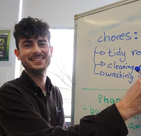 ACFE, a man writing on a white board Image