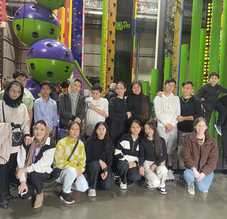 Group of young people in front of an indoor climbing wall Image