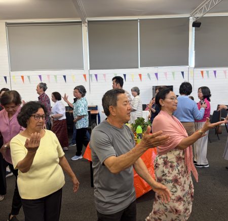 The Cambodian Group is dancing around a room Image