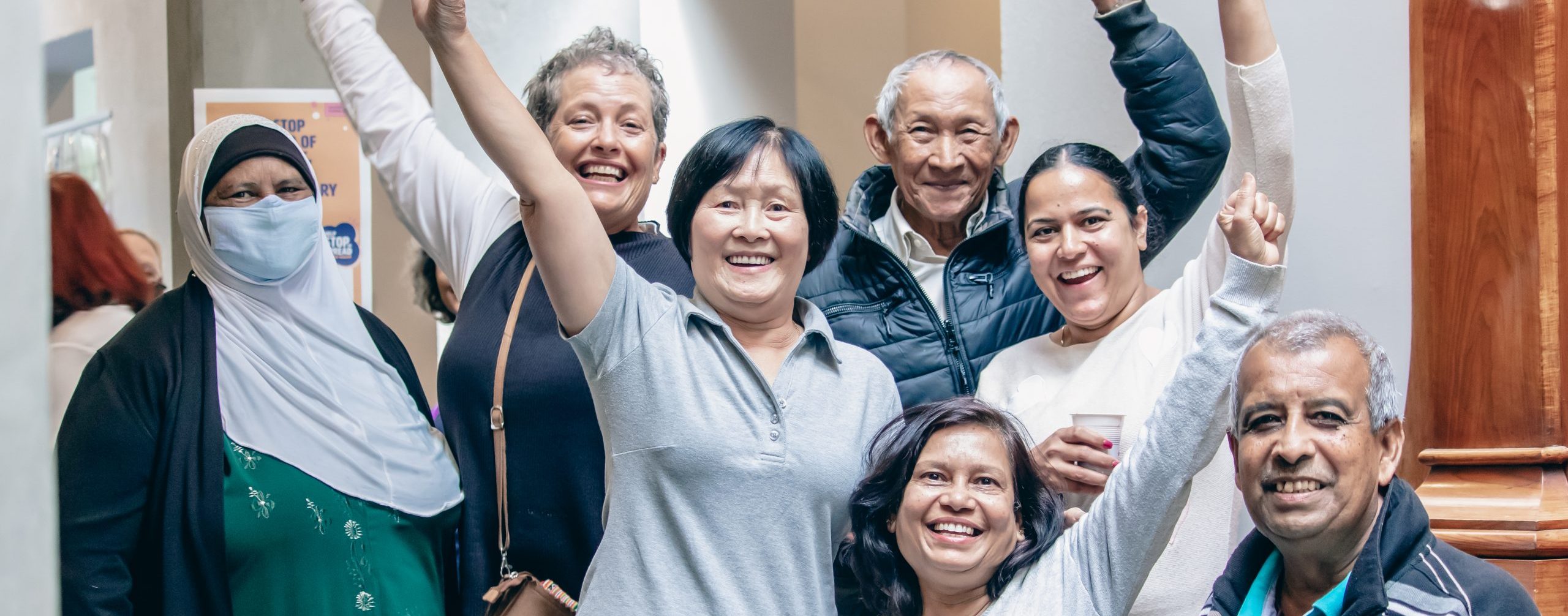 group of women and men in centre smiling at camera