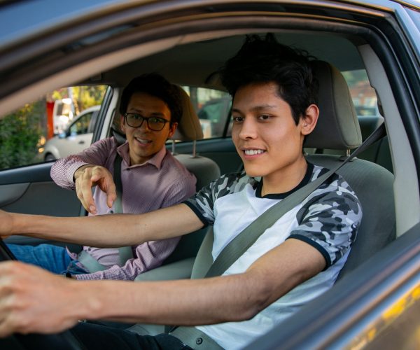 two young men in a driving lesson