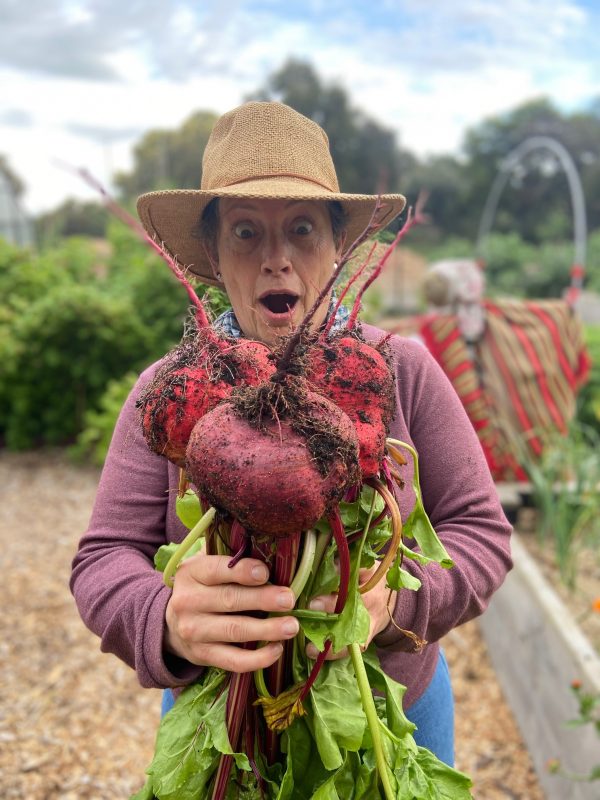 A woman holding up beetroot