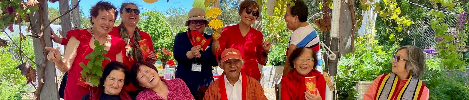 Group at the Hive dressed in red for Lunar New Year. Everyone is laughing and smiling