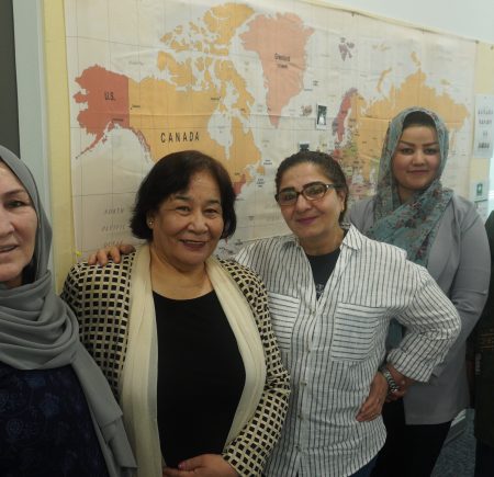 Five carers stand smiling at the camera Image