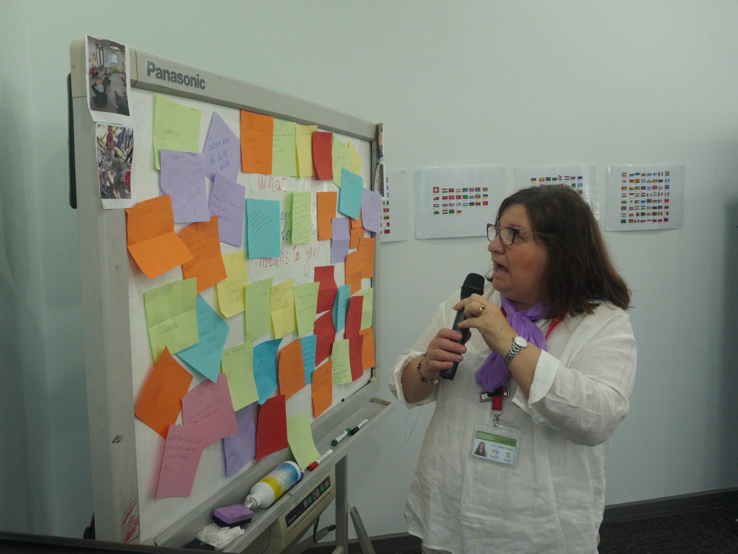 SMRC Support for Carers Coordinator standing in front of a whiteboard covered in sticky notes