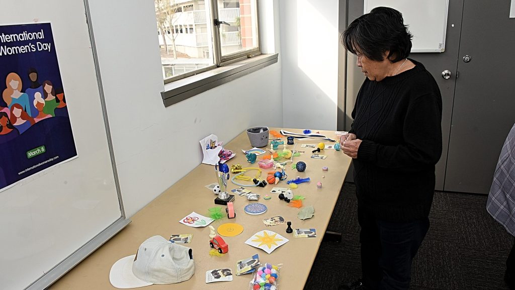 One participant looks at a table of items